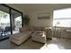 Relaxing living room with plush seating, access to balcony, and bright natural light at 16904 Vardon Ter # 208, Lakewood Ranch, FL 34211