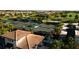 Aerial view of tennis courts in community, lush landscaping and beautiful neighborhood at 16904 Vardon Ter # 208, Lakewood Ranch, FL 34211