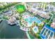 Aerial view of a community pool, clubhouse, tennis courts, and lake surrounded by lush landscaping at 18008 Waterville Pl, Bradenton, FL 34202