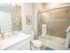 Well-lit bathroom featuring a glass-enclosed shower, modern vanity, and stylish fixtures at 18008 Waterville Pl, Bradenton, FL 34202