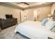 Bedroom featuring an entrance to a bathroom, a TV, and neutral colors at 18008 Waterville Pl, Bradenton, FL 34202