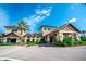 Attractive clubhouse with stone and siding exterior, porte-cochere, and lush landscaping in a vibrant community at 18008 Waterville Pl, Bradenton, FL 34202