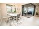 Bright dining area with a modern chandelier, patio access, and backyard view at 18008 Waterville Pl, Bradenton, FL 34202