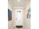 Inviting entryway featuring a decorative front door, modern lighting, and stylish wall art at 18008 Waterville Pl, Bradenton, FL 34202