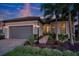Charming single-story home with a two-car garage, lush landscaping, and beautiful paver driveway at 18008 Waterville Pl, Bradenton, FL 34202