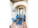 Inviting front porch with tiled floor, seating, and stylish decor, creating a welcoming entry at 18008 Waterville Pl, Bradenton, FL 34202
