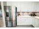 Bright kitchen featuring stainless steel appliances and white cabinets at 18008 Waterville Pl, Bradenton, FL 34202