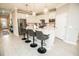 Bright kitchen featuring an island with bar stool seating, stainless steel appliances, and pendant lighting at 18008 Waterville Pl, Bradenton, FL 34202