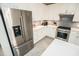 Bright kitchen featuring stainless steel appliances and white cabinets with gray backsplash at 18008 Waterville Pl, Bradenton, FL 34202