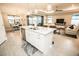 Open-concept kitchen with island, stainless steel appliances, and seamless flow into the dining and living areas at 18008 Waterville Pl, Bradenton, FL 34202