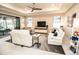 Elegant living room featuring a tray ceiling, modern furniture, and seamless indoor-outdoor flow at 18008 Waterville Pl, Bradenton, FL 34202