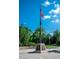 Patriotic monument featuring the American flag, honoring the United States Armed Forces, under a clear blue sky at 18008 Waterville Pl, Bradenton, FL 34202