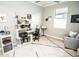 Bright office space with a modern desk, shelving, and comfortable seating area at 18008 Waterville Pl, Bradenton, FL 34202