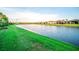 Scenic view of the tranquil community pond with lush green grass and well-maintained landscaping at 18008 Waterville Pl, Bradenton, FL 34202
