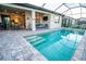 Covered pool area featuring a beautiful in-ground pool, outdoor furniture, and an open living space at 18008 Waterville Pl, Bradenton, FL 34202
