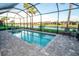 Screened-in pool offers privacy and a picturesque view of the surrounding landscape at 18008 Waterville Pl, Bradenton, FL 34202