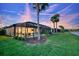 A relaxing private pool area with screened-in lanai and lush tropical landscaping in the backyard at 18008 Waterville Pl, Bradenton, FL 34202