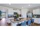 Modern kitchen featuring stainless steel appliances, a kitchen island, and ample cabinet space at 18212 Wheathouse Pl, Lakewood Ranch, FL 34211