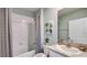 Clean bathroom with a shower-tub combo, decorative plant art, and granite countertop at 18227 Canopy Pl, Lakewood Ranch, FL 34211