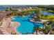 Beautiful community pool featuring ample seating, lush landscaping, and stunning water views on a bright, sunny day at 18231 Canopy Pl, Lakewood Ranch, FL 34211