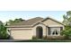 Charming single-story home featuring a two-car garage, stone accents, manicured lawn, and inviting covered entry at 18309 Canopy Pl, Lakewood Ranch, FL 34211