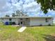 Spacious backyard with lush green grass and a covered patio, perfect for outdoor enjoyment at 1902 24Th W Ave, Bradenton, FL 34205