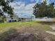 Large backyard featuring healthy grass, shade trees, and partially fenced in yard at 1902 24Th W Ave, Bradenton, FL 34205