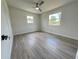 Bright bedroom with wood-look floors, ceiling fan, and natural light from the two windows at 1902 24Th W Ave, Bradenton, FL 34205