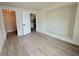 Bedroom featuring wood-look floors, a doorway, a closet, and plenty of natural light at 1902 24Th W Ave, Bradenton, FL 34205