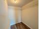 Small closet with wood-look floors and wire shelving for storage and organization at 1902 24Th W Ave, Bradenton, FL 34205