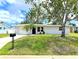 Charming single-story home with a well-maintained lawn, mature trees, and a welcoming front entrance at 1902 24Th W Ave, Bradenton, FL 34205