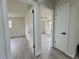 Hallway with modern flooring leading to bedrooms with natural light at 1902 24Th W Ave, Bradenton, FL 34205