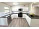 Well-lit kitchen featuring white cabinets, granite countertops, stainless steel appliances, and subway tile backsplash at 1902 24Th W Ave, Bradenton, FL 34205