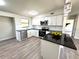 Bright kitchen featuring white cabinets, granite countertops, stainless steel appliances, and an island with bar seating at 1902 24Th W Ave, Bradenton, FL 34205