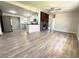Bright open-concept living room featuring modern flooring, a brick fireplace, and an eat-in kitchen with stainless steel appliances at 1902 24Th W Ave, Bradenton, FL 34205
