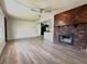 Spacious living room featuring a brick fireplace, light-colored walls, new floors, and an eat-in kitchen at 1902 24Th W Ave, Bradenton, FL 34205