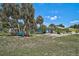 Spacious backyard offering mature landscaping and ample room for outdoor activities, relaxation, and gardening at 2127 Corfell St, Port Charlotte, FL 33948