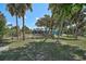 Tranquil backyard view showcasing mature trees and foliage, complemented by a classic fence for a private setting at 2127 Corfell St, Port Charlotte, FL 33948