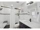 Modern bathroom featuring marble tile, black fixtures and an enclosed shower at 2127 Corfell St, Port Charlotte, FL 33948