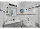 Well-lit bathroom with updated fixtures, decorative tile, and modern vanity at 2127 Corfell St, Port Charlotte, FL 33948