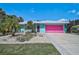 Attractive single-story home with a unique, vibrant exterior paint scheme and well-kept landscaping at 2127 Corfell St, Port Charlotte, FL 33948