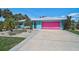 Charming single-story home with colorful exterior paint and a well-maintained front yard at 2127 Corfell St, Port Charlotte, FL 33948