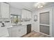 Charming kitchen featuring white cabinets, marble countertops, and stainless steel appliances at 2127 Corfell St, Port Charlotte, FL 33948