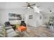 Comfortable living space with wood-look floors open to dining area with modern ceiling fan at 2127 Corfell St, Port Charlotte, FL 33948