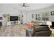 Cozy living room with stylish floors, comfortable seating, and natural light from large window at 2127 Corfell St, Port Charlotte, FL 33948
