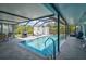 Inviting screened-in pool area with a grill, lounge chairs, and ample space for outdoor entertainment at 2127 Corfell St, Port Charlotte, FL 33948