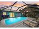 Enjoy this beautiful screened pool with a custom bar and a view of the picturesque sunset at 2127 Corfell St, Port Charlotte, FL 33948