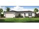 Charming single-story home with a two-car garage, landscaped yard, and inviting curb appeal at 22318 Alcorn Ave, Port Charlotte, FL 33952