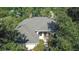 An aerial view of a house with a gray roof surrounded by lush green trees and landscaping at 2809 112Th E Ter, Parrish, FL 34219