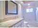 Well-lit bathroom featuring dual sinks, granite countertops, white cabinets, and a tub at 2809 112Th E Ter, Parrish, FL 34219